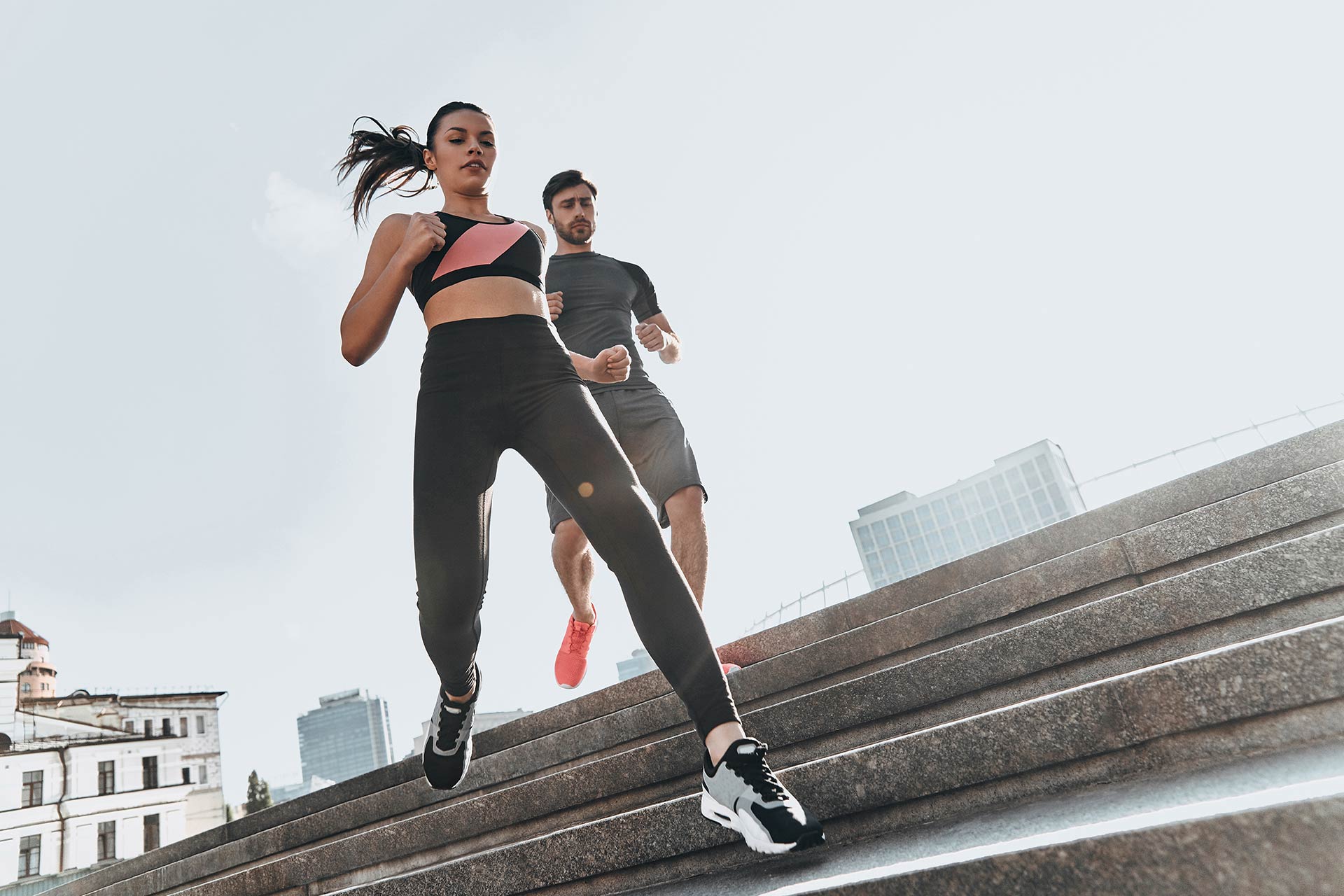 Two runners training together on a flight of outdoor steps